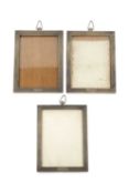 A set of seven George V silver rectangular photograph frames, with engine turned decoration, and
