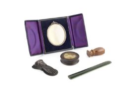 A 19th century papier mache circular box, the cover inset with a glazed embossed gilt plaque