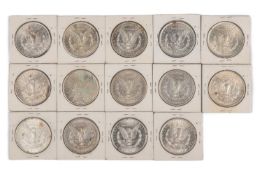 A collection of 14 American silver dollars