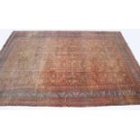 A Persian light brown ground carpet
