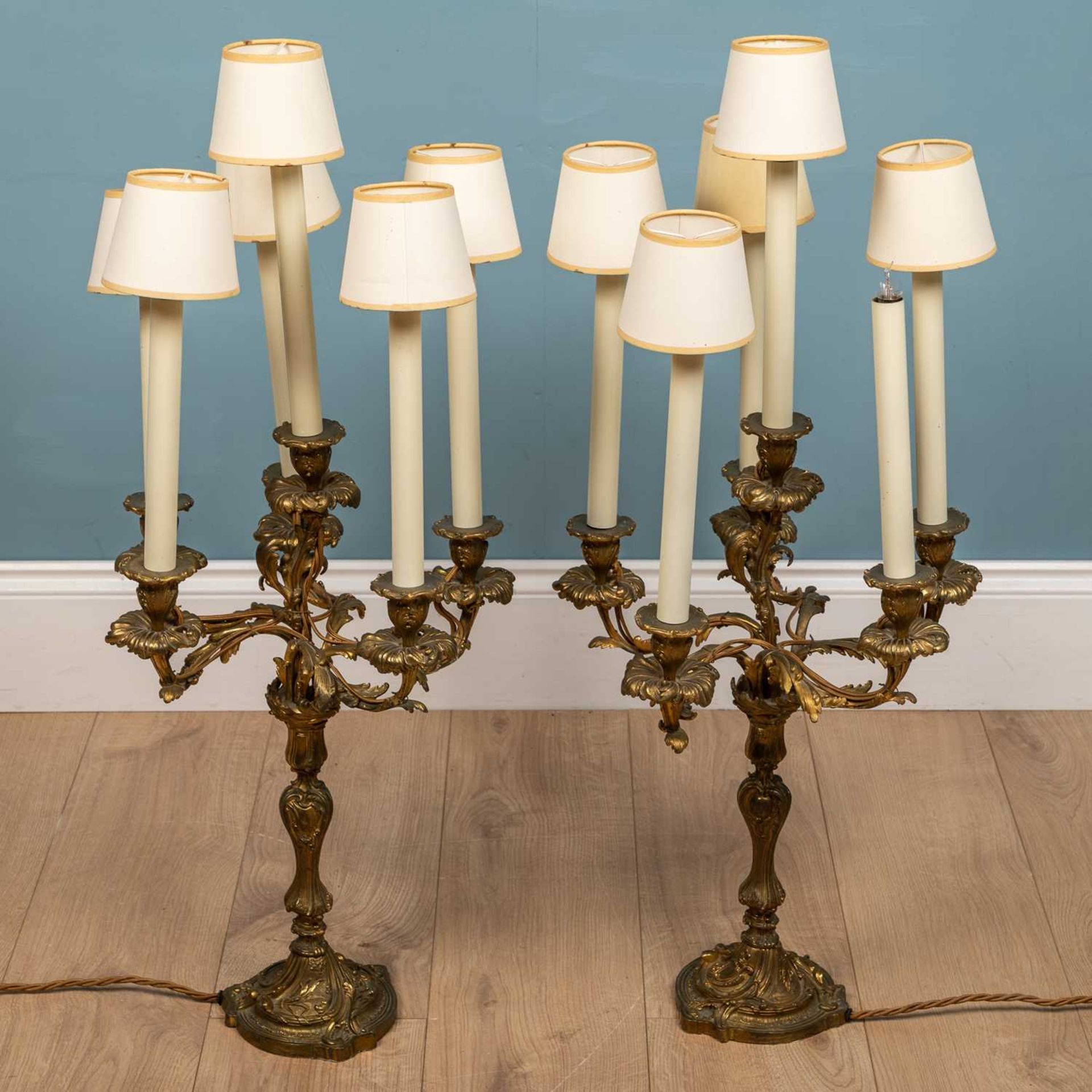 A pair of Rococo style continental gilt metal candelabra style lamp holders