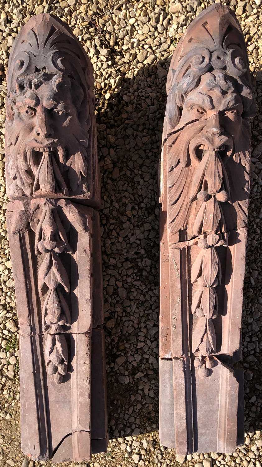 A pair of carved red sandstone architectural scrolling corbels