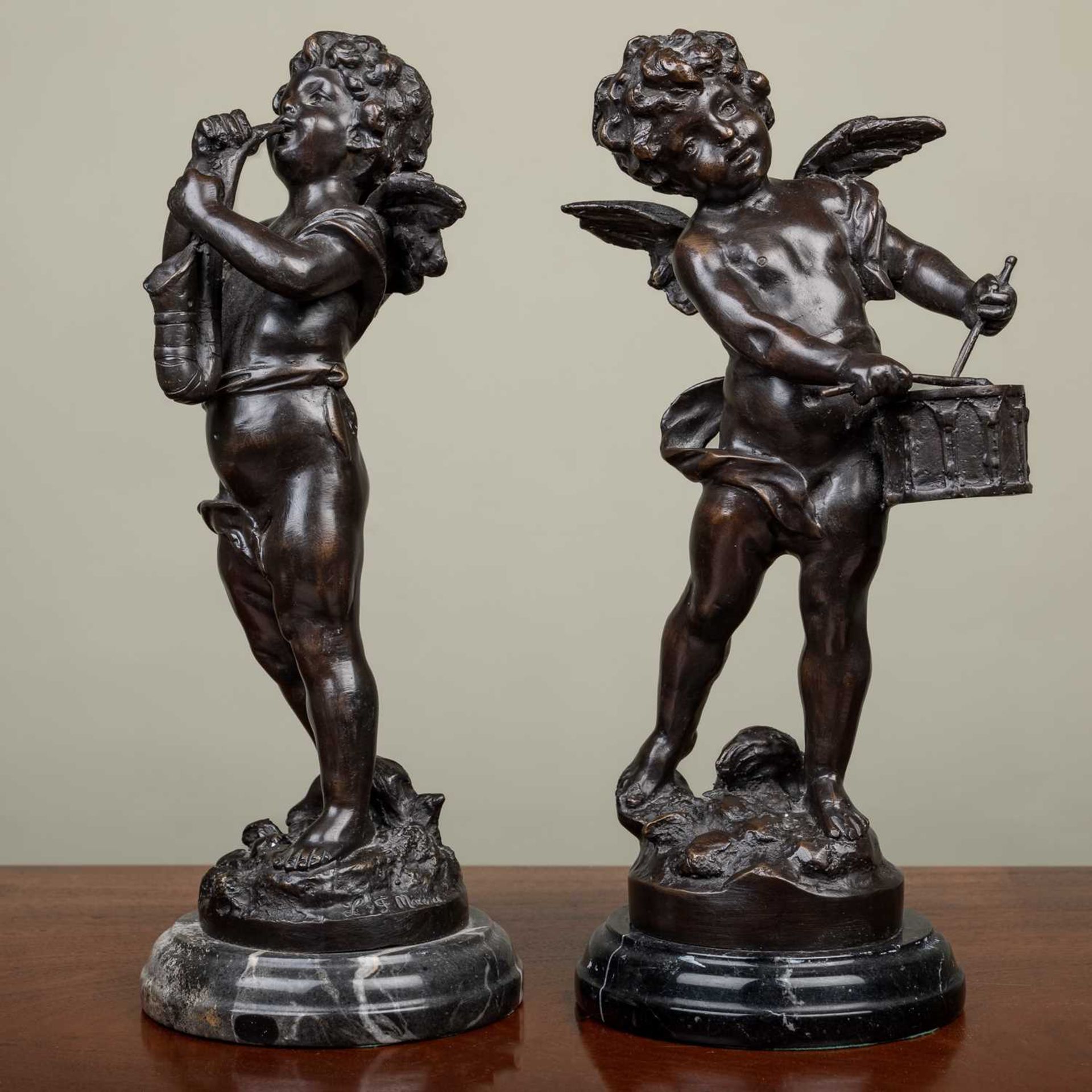 A pair of Bronze figures of cherubs