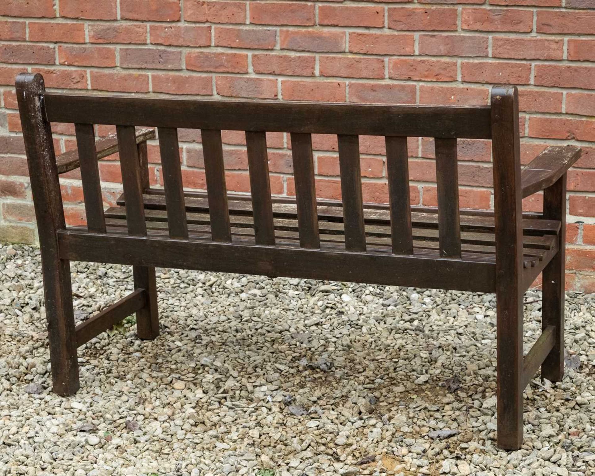 A brown stained teak garden two-seater bench - Bild 3 aus 3