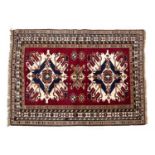 A Middle Eastern red ground woolen rug