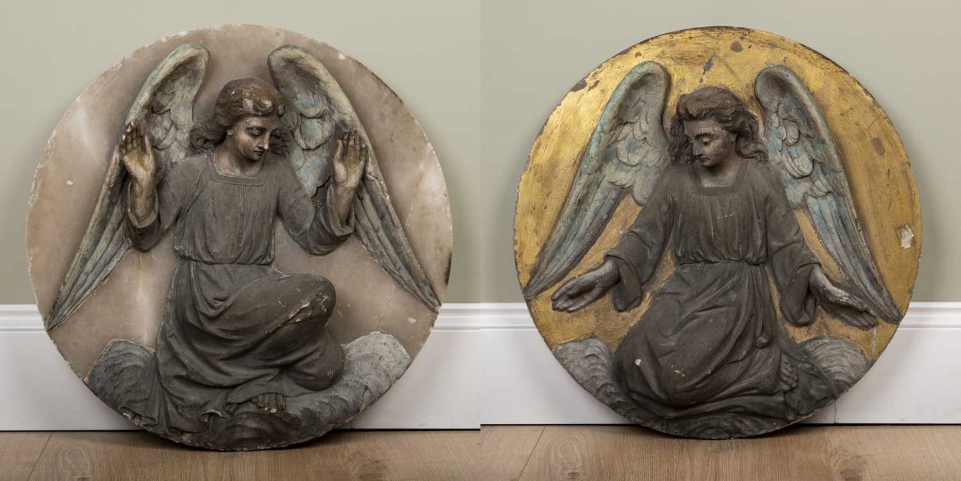 A pair of carved alabaster roundels