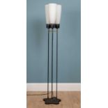 A three branch tall metal black and brass design floor lamp