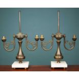 A pair of French empire style brass lamps