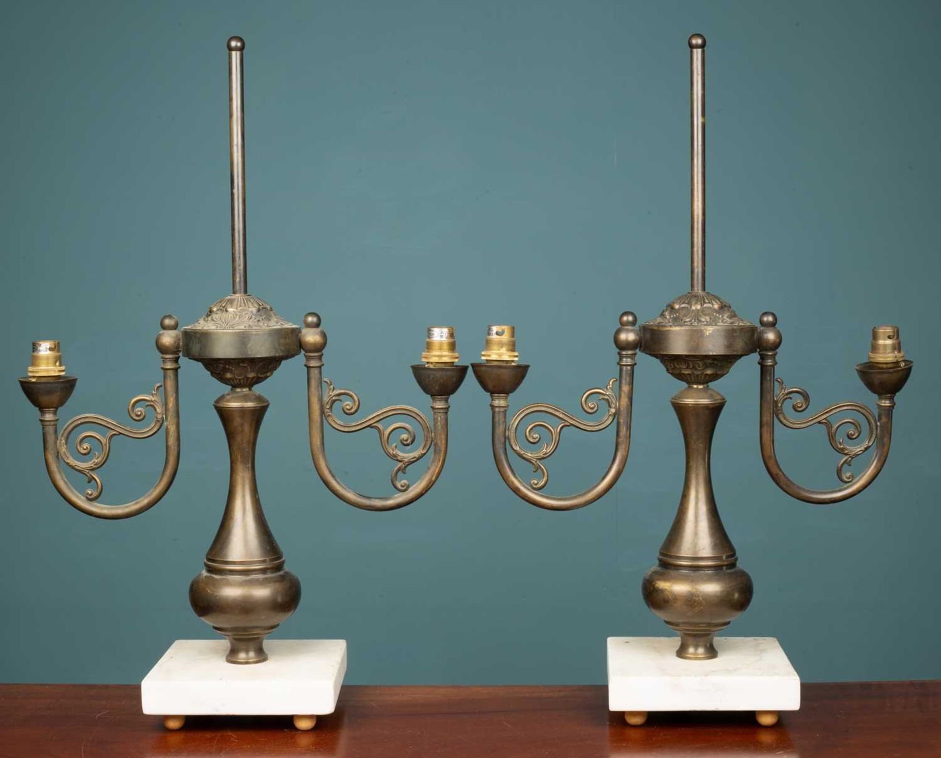 A pair of French empire style brass lamps