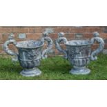 A pair of antique lead urns