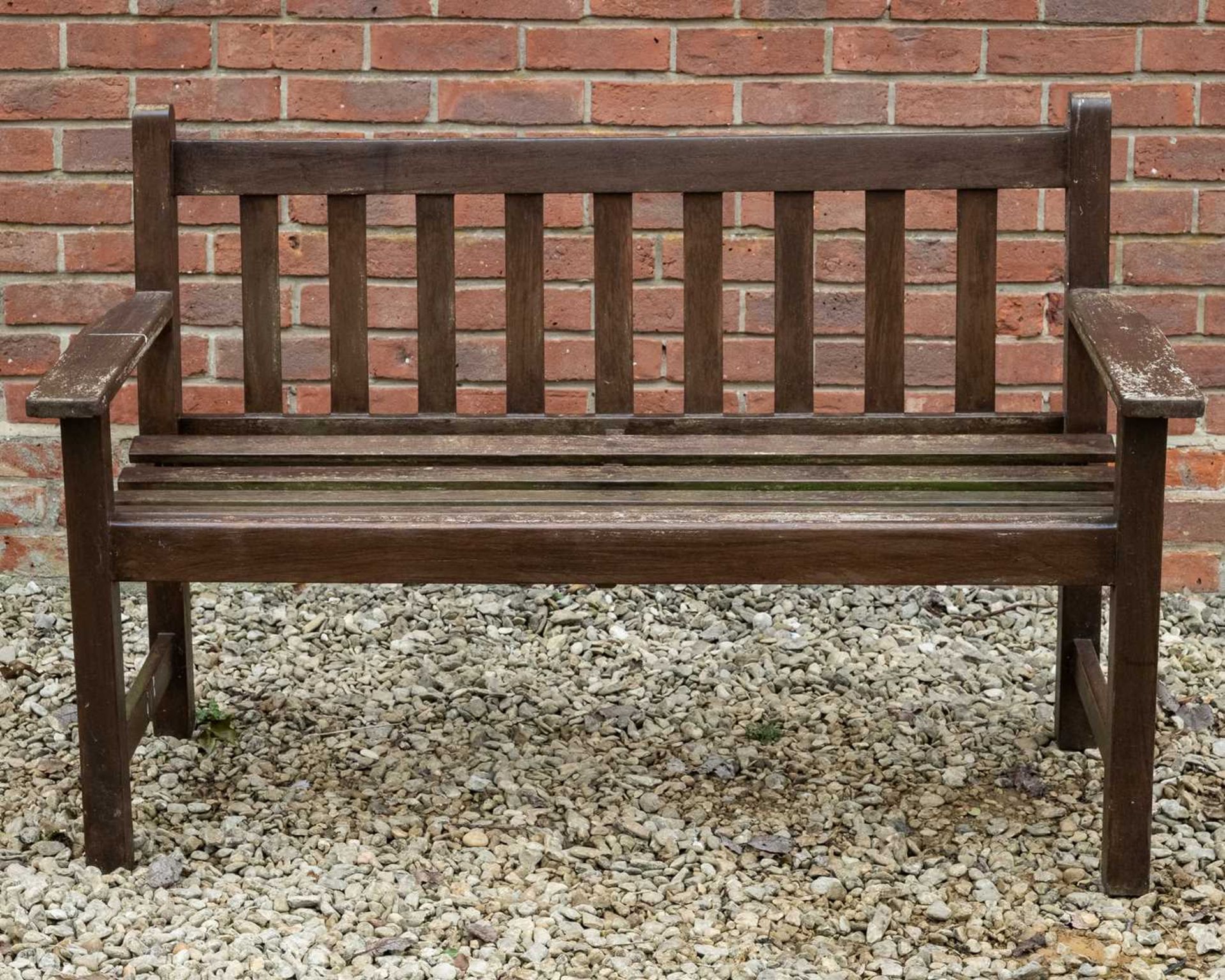 A brown stained teak garden two-seater bench