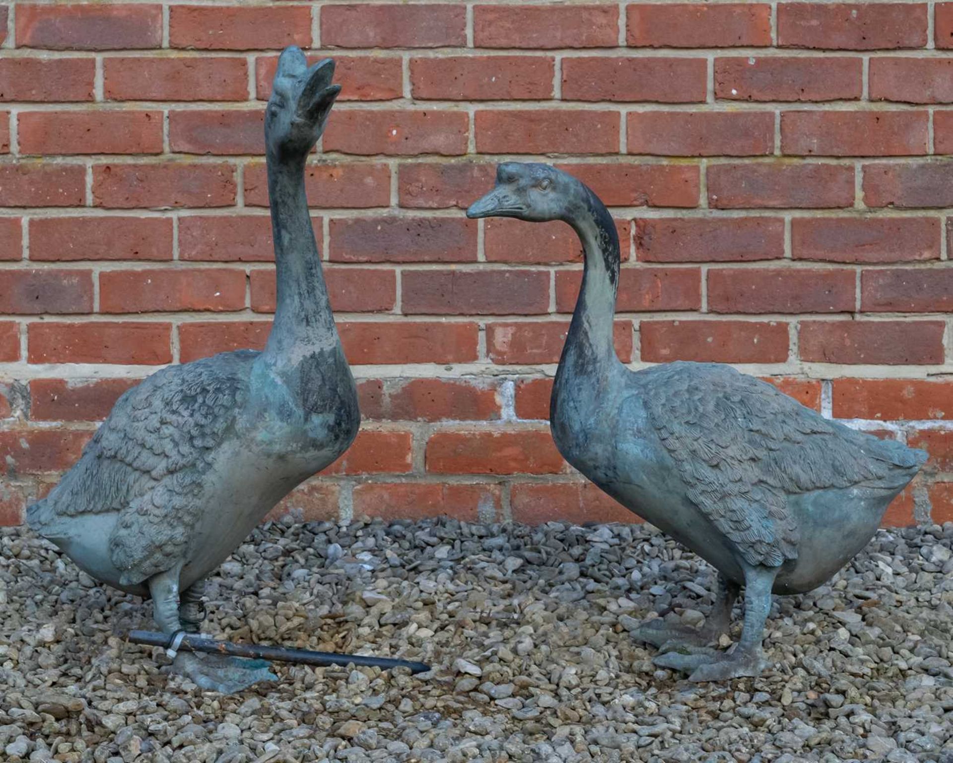 A pair of contemporary bronze sculptures of geese