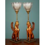 A pair of French art deco empire gilded Sphinx table lamps