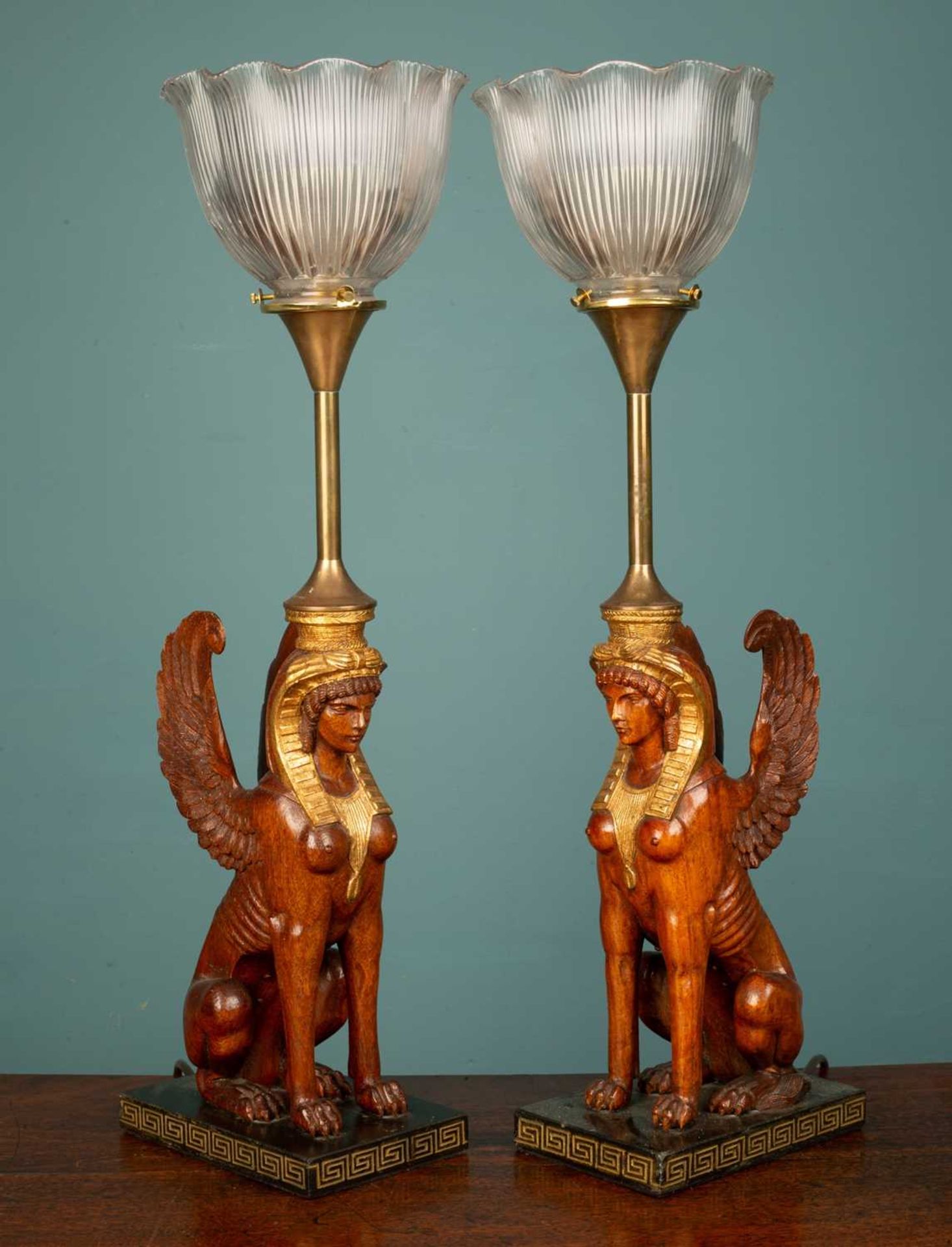 A pair of French art deco empire gilded Sphinx table lamps