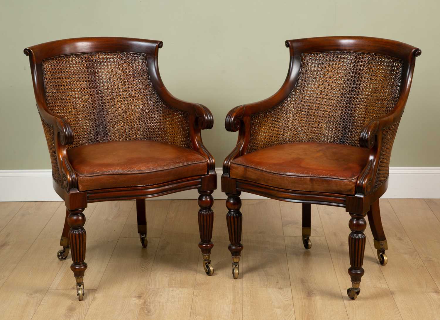 A pair of William IV style caned bergeres