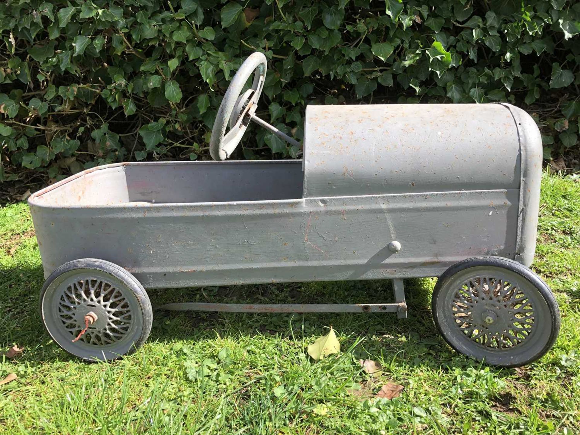 A mid-20th century grey painted child's pedal car