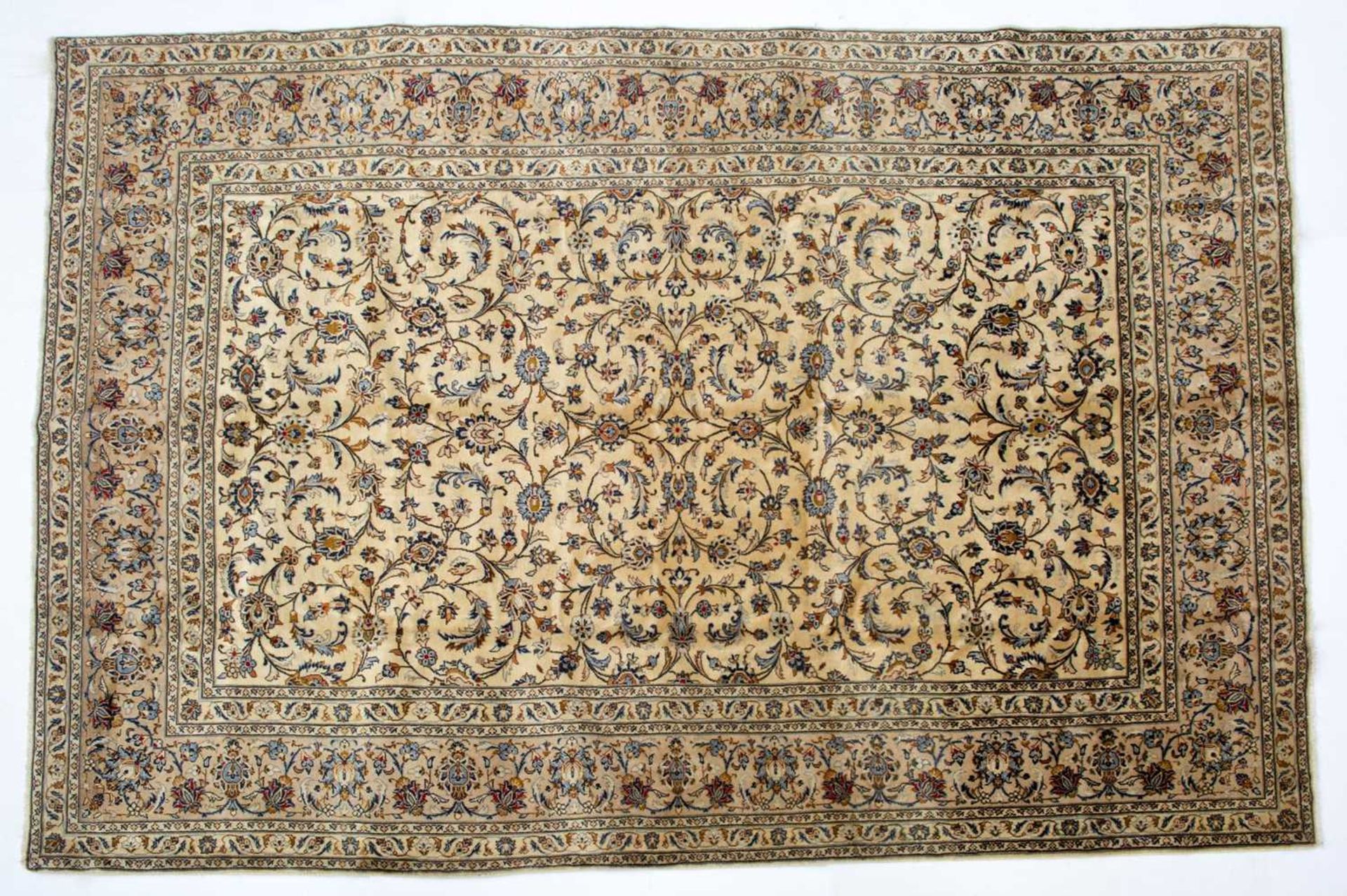 A Middle Eastern Kashan cream ground carpet