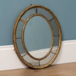 An antique small oval wall mirror