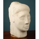 A carved limestone head of a young woman