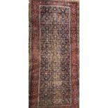 An antique Oriental blue ground rug