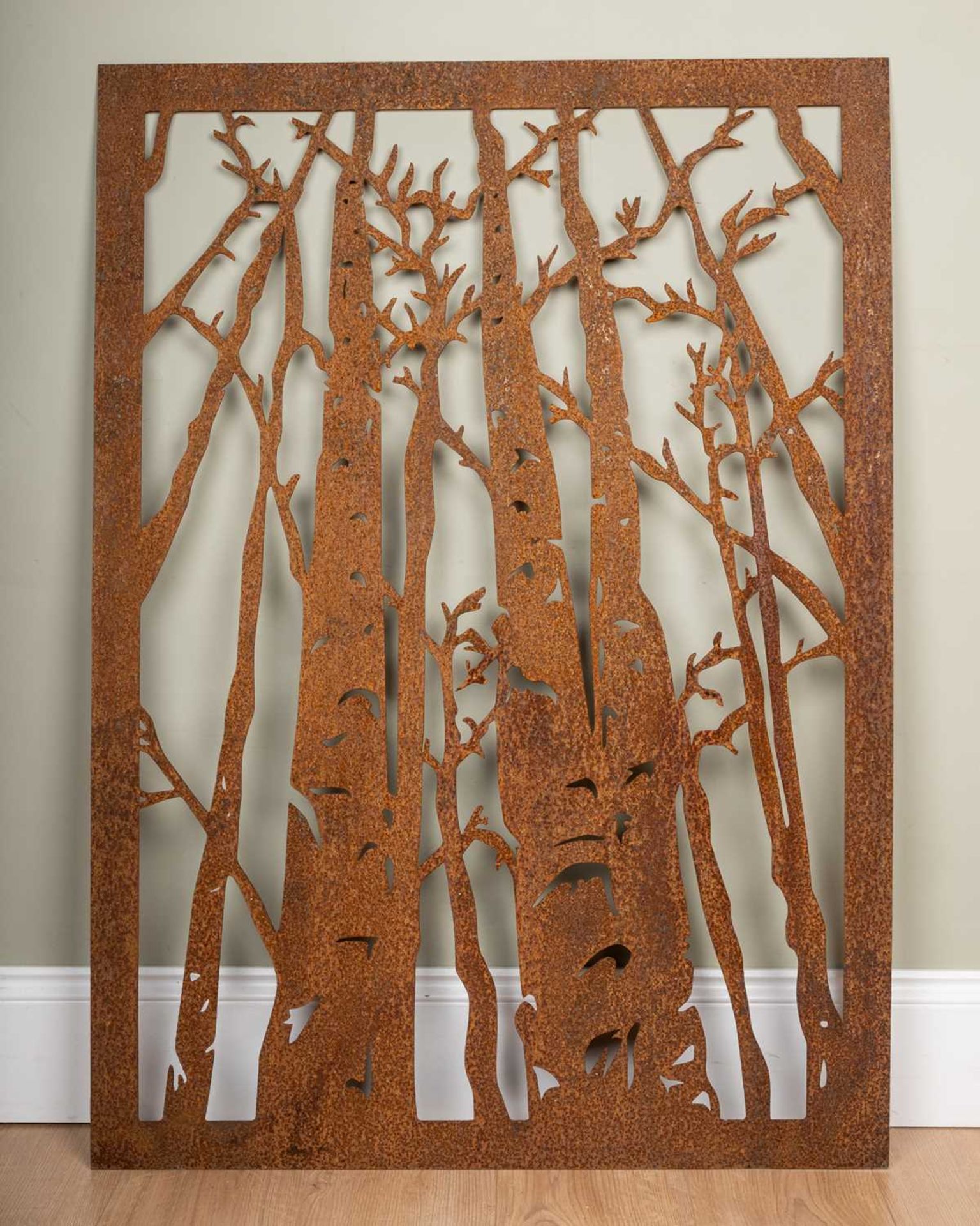 A pierced steel silhouette picture of autumn woodland trees