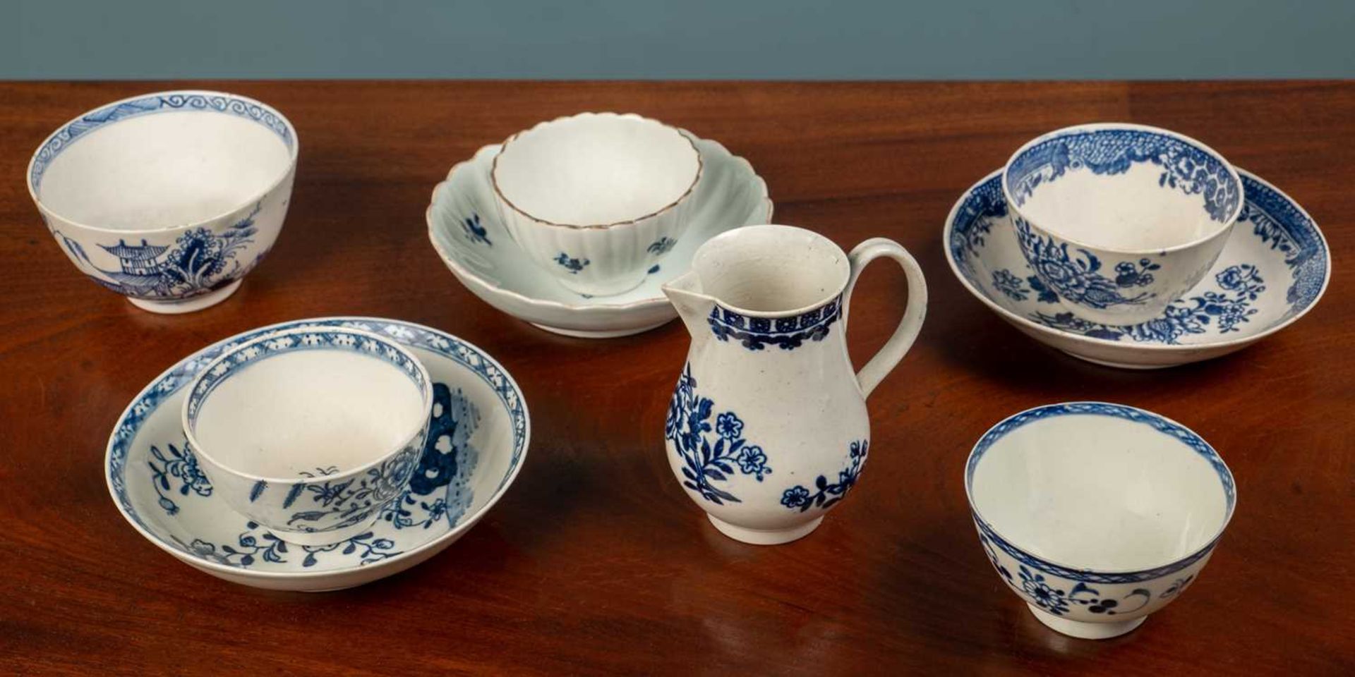 A small group of 18th century porcelain tea bowls and a sparrow beak jug