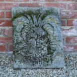 A large well weathered mossy plaque of a green man