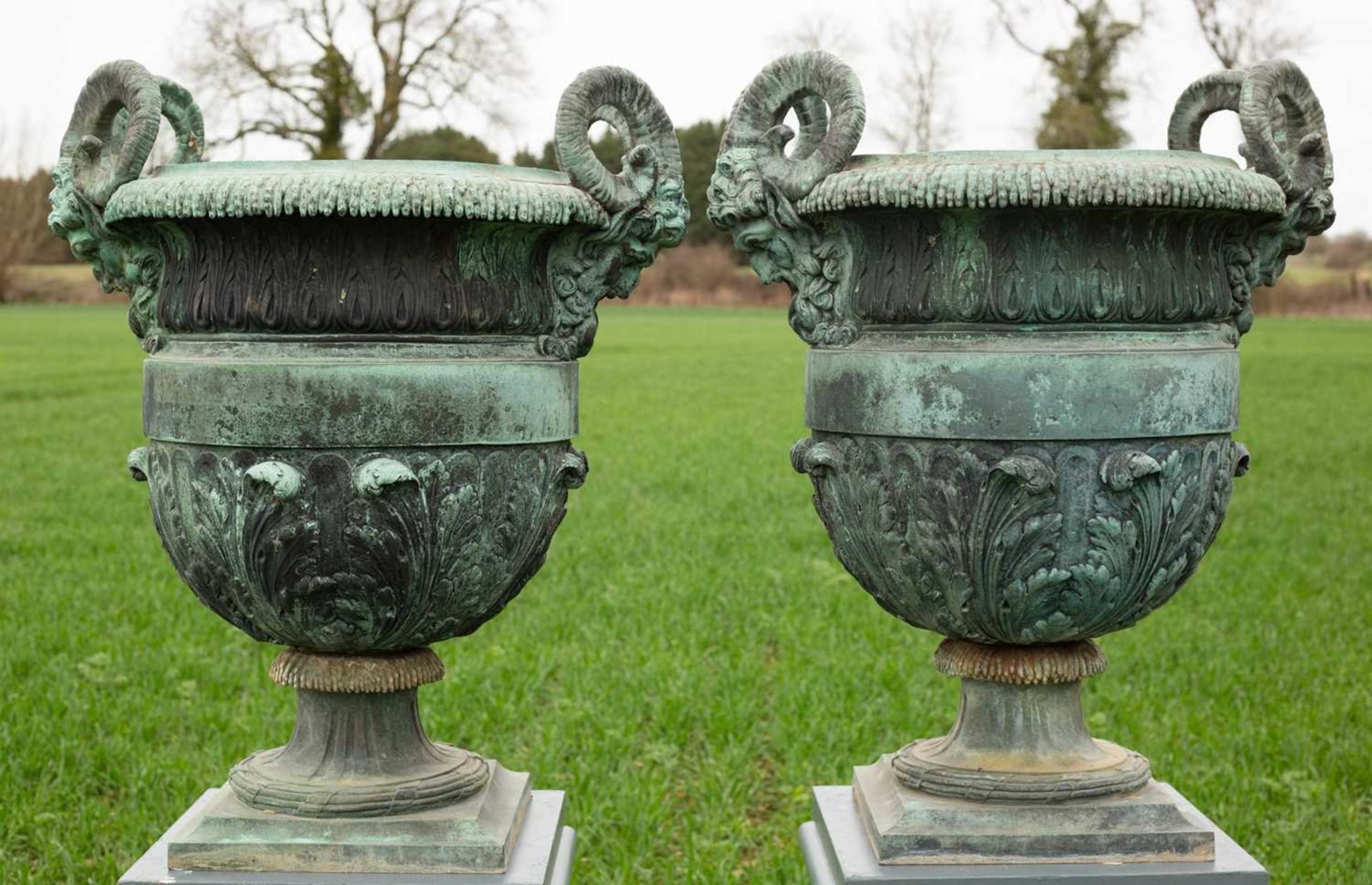 A pair of 18th or 19th century bronze urns designed by Claude Ballin