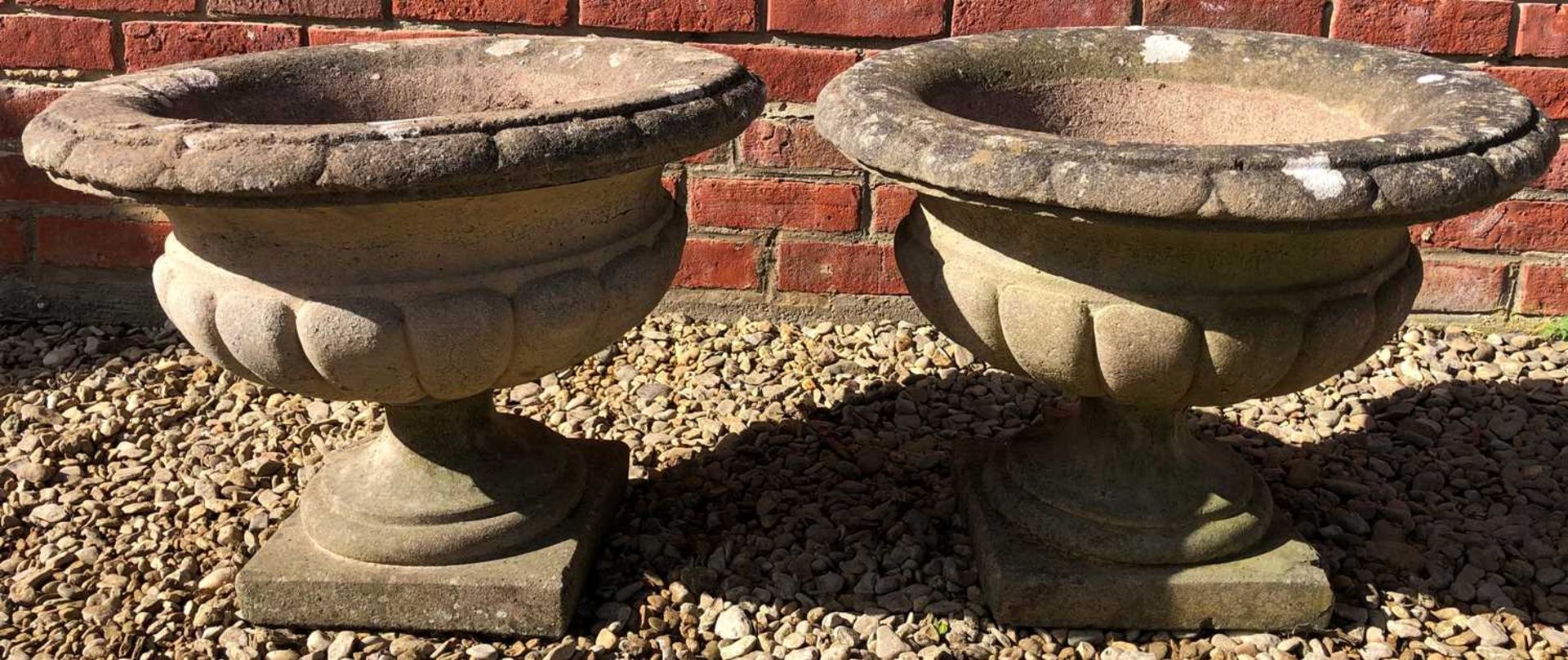 A pair of cast reconstituted stone urns