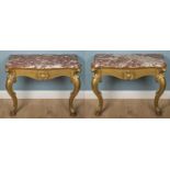 A pair of antique carved and gilt oak console tables