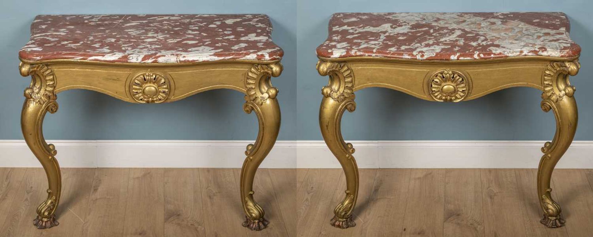 A pair of antique carved and gilt oak console tables