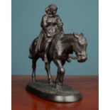 A Russian cast iron sculpture of a figure on the back of a mule