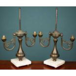 A pair of French empire style brass two branch candelabra lamps