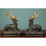 A pair of bronze stag sculptures