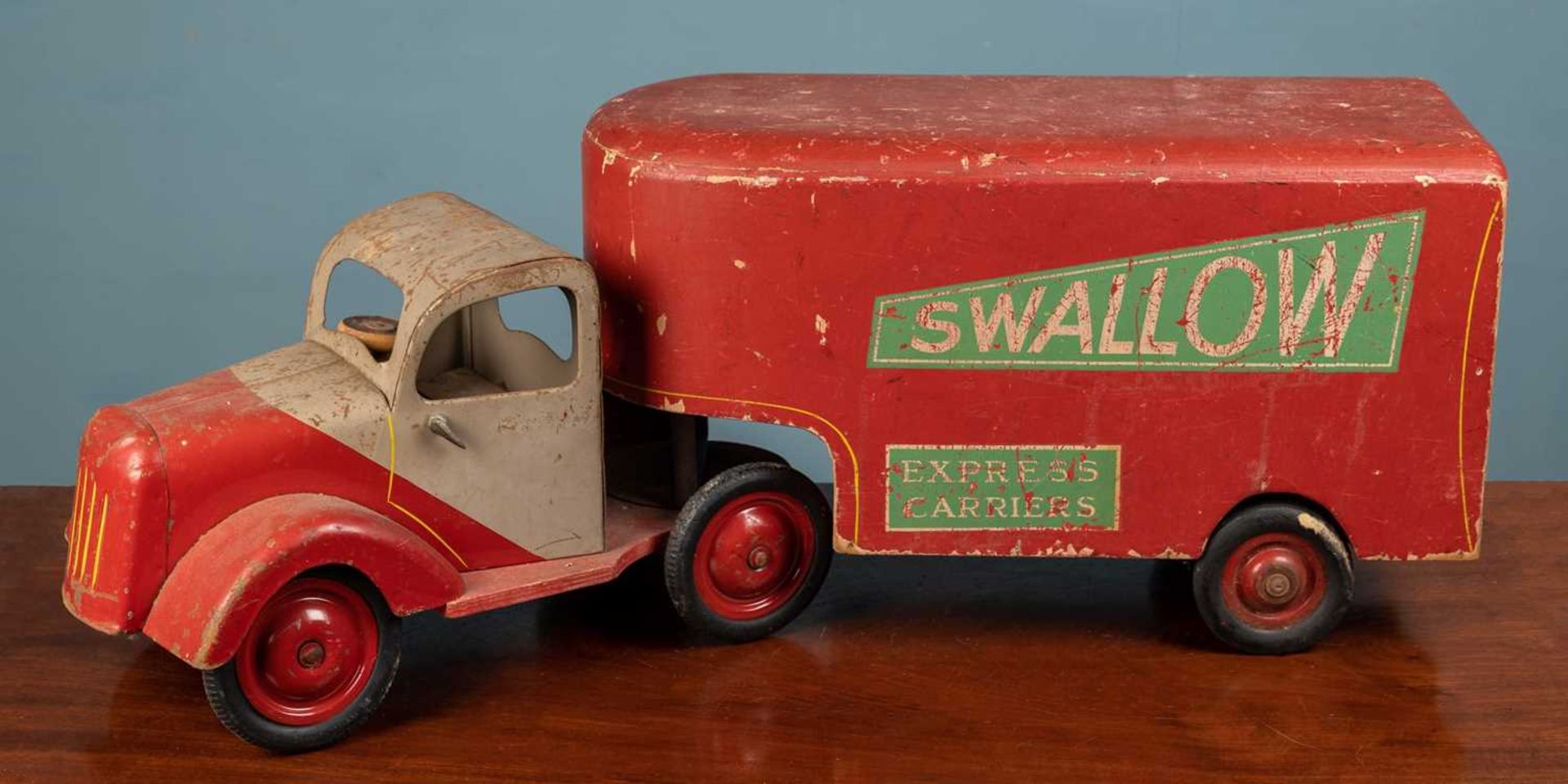 A mid-20th century painted wood and tin toy lorry