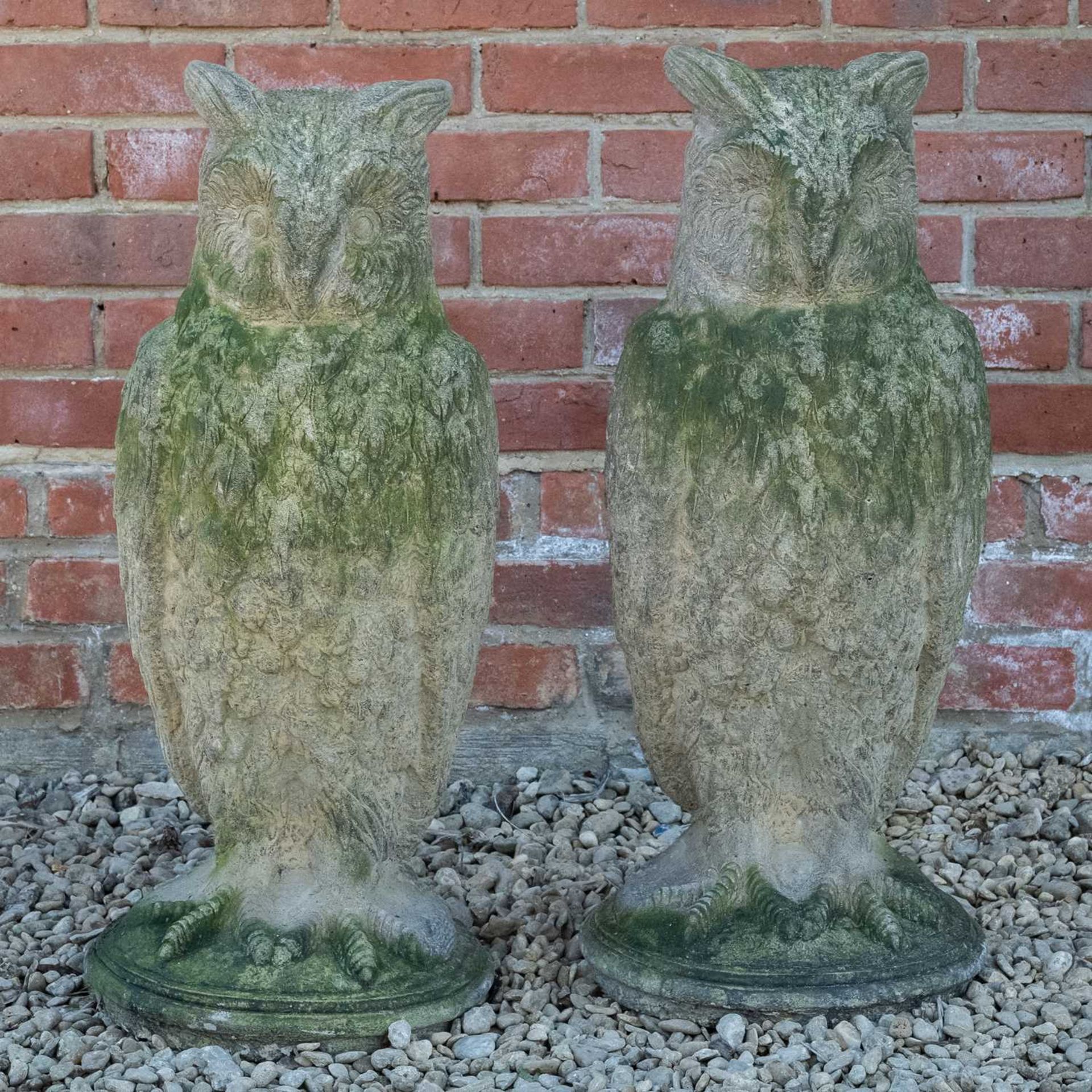A pair of antique reconstituted stone owl sculptures