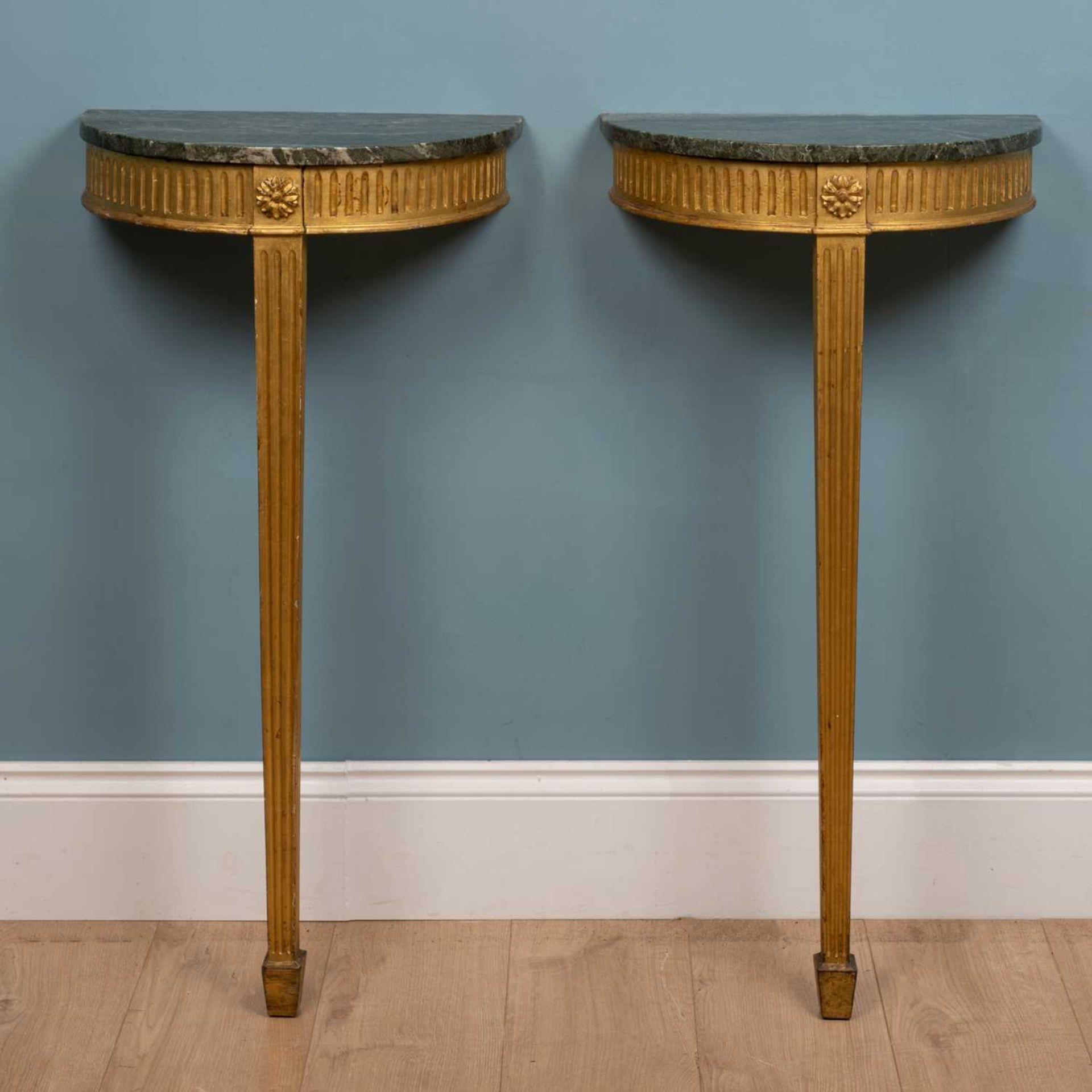 A pair of 19th century green marble-topped gilt console tables