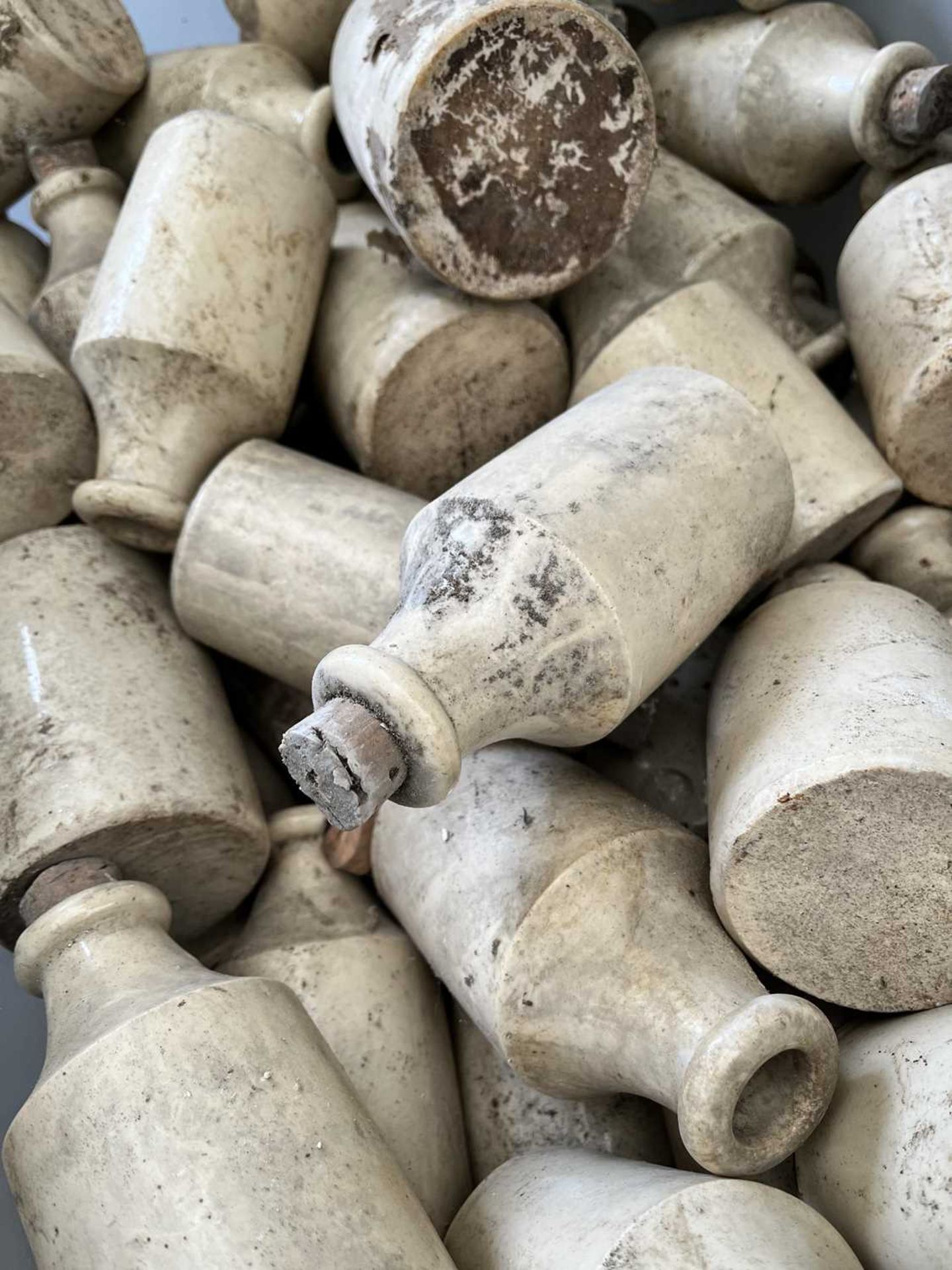 A collection of antique stoneware furniture polish bottles