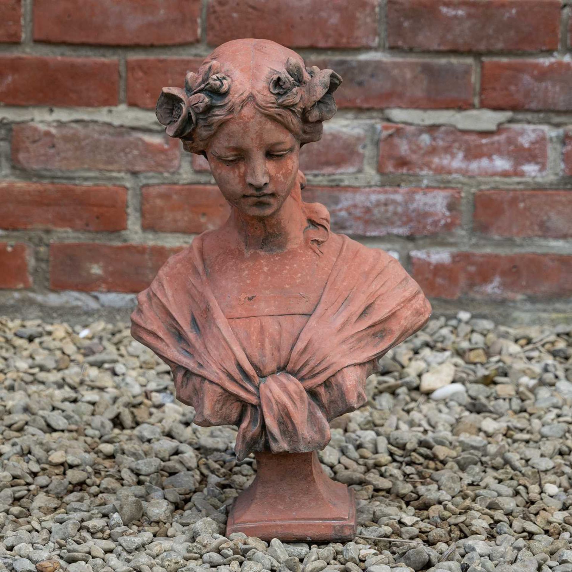 An Art Nouveau cast stone terracotta style bust