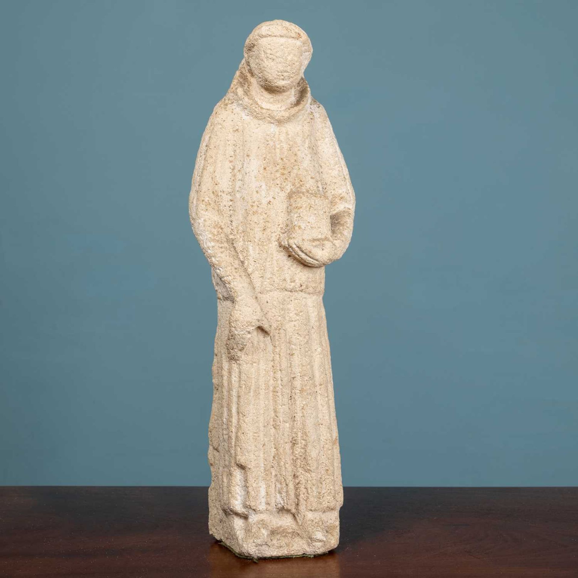 A carved limestone sculpture of a monk