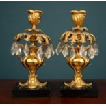 A pair of antique ormolu candlesticks