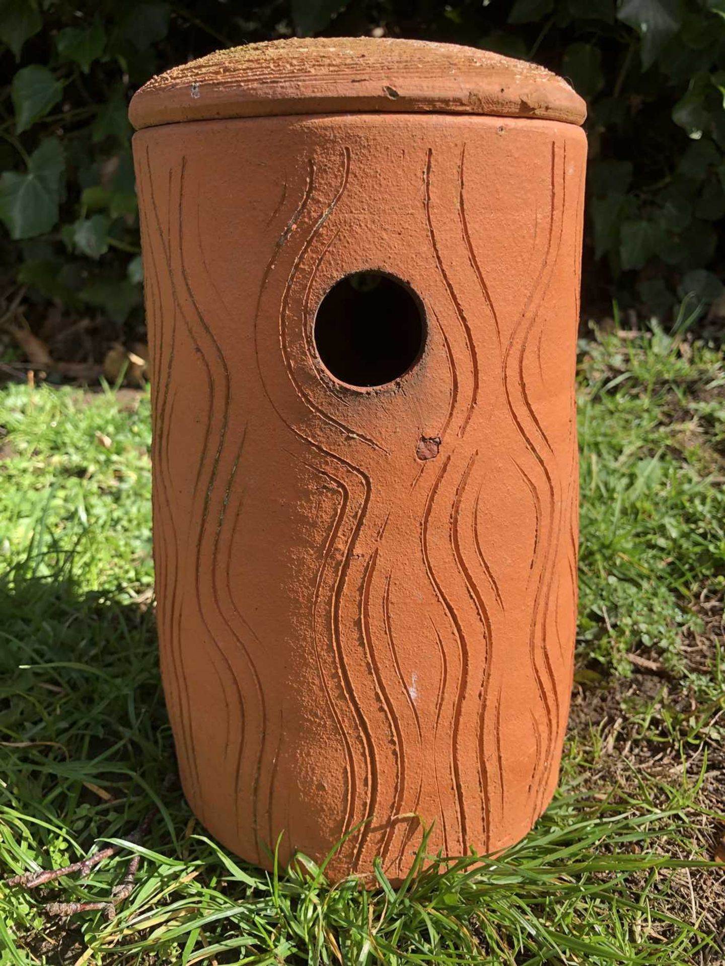 A mid to late 20th century terracotta hanging bird box