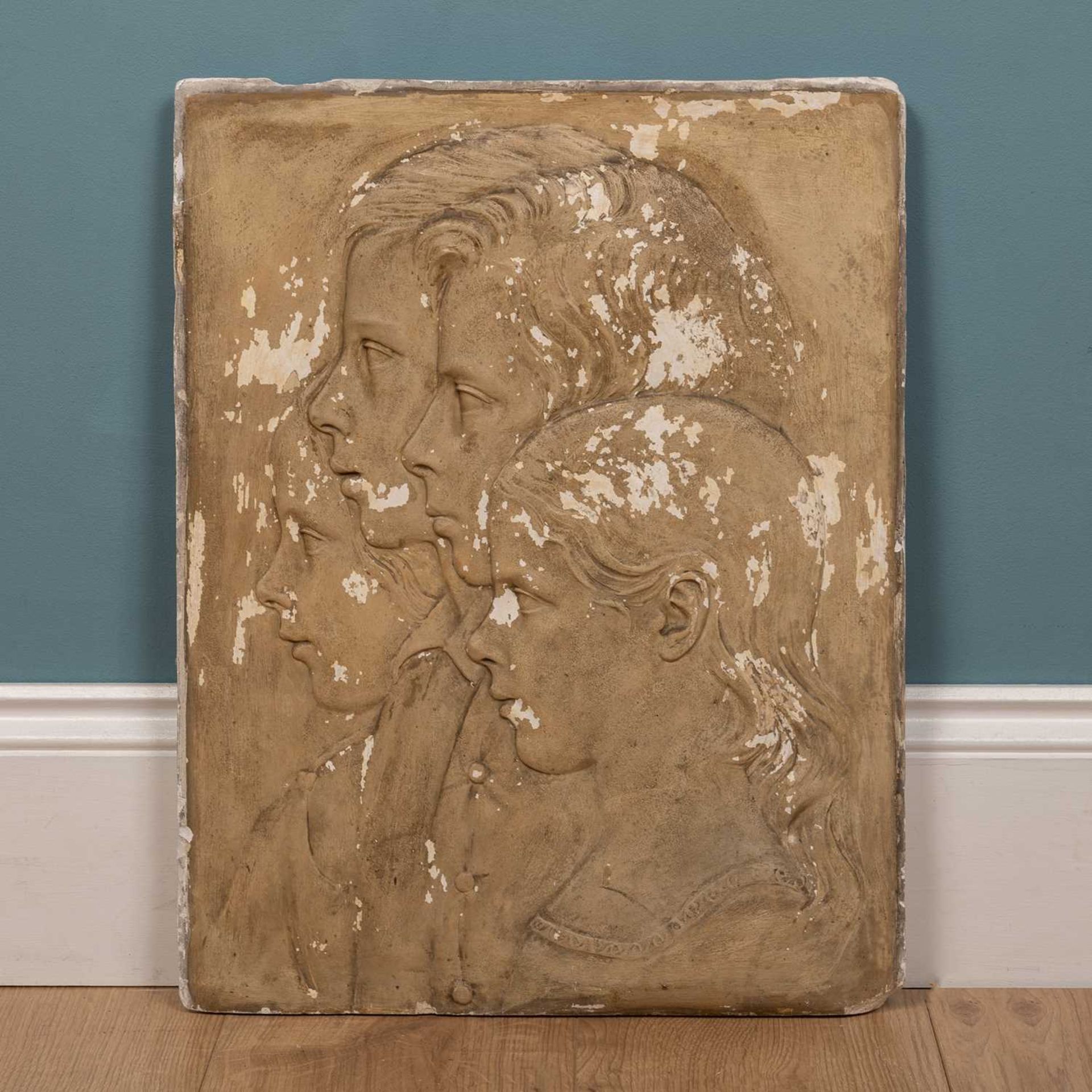 A 19th Century plaster plaque with profile portraits in relief of four children