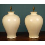 A pair of cream pottery table lamps