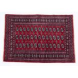 A red ground Baluch rug