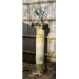 A sandstone column with a green painted wrought iron armillary sundial