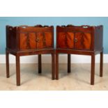 A pair of mahogany bedside cabinets