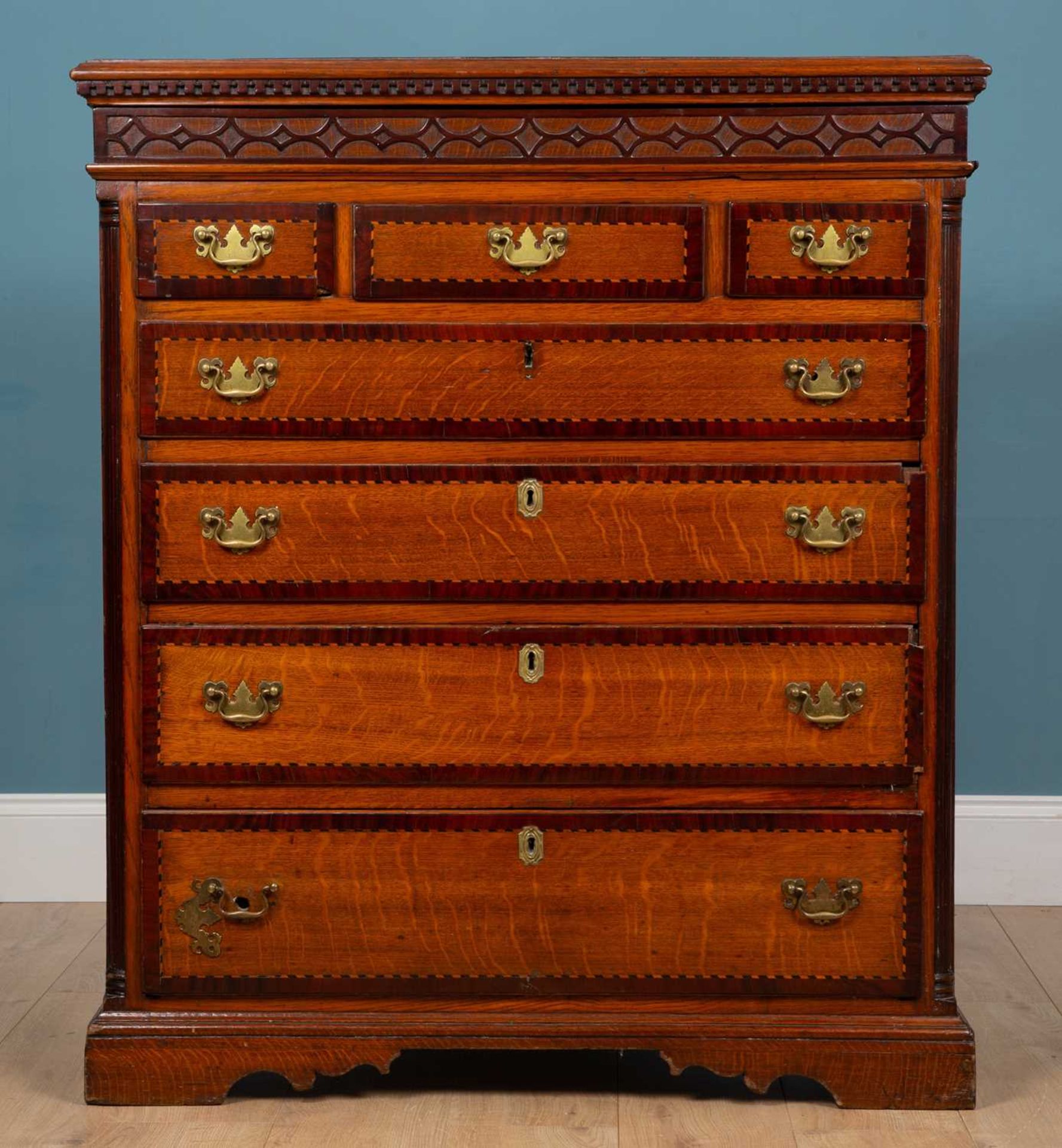 A 19th century oak chest of three short and four long graduated drawer