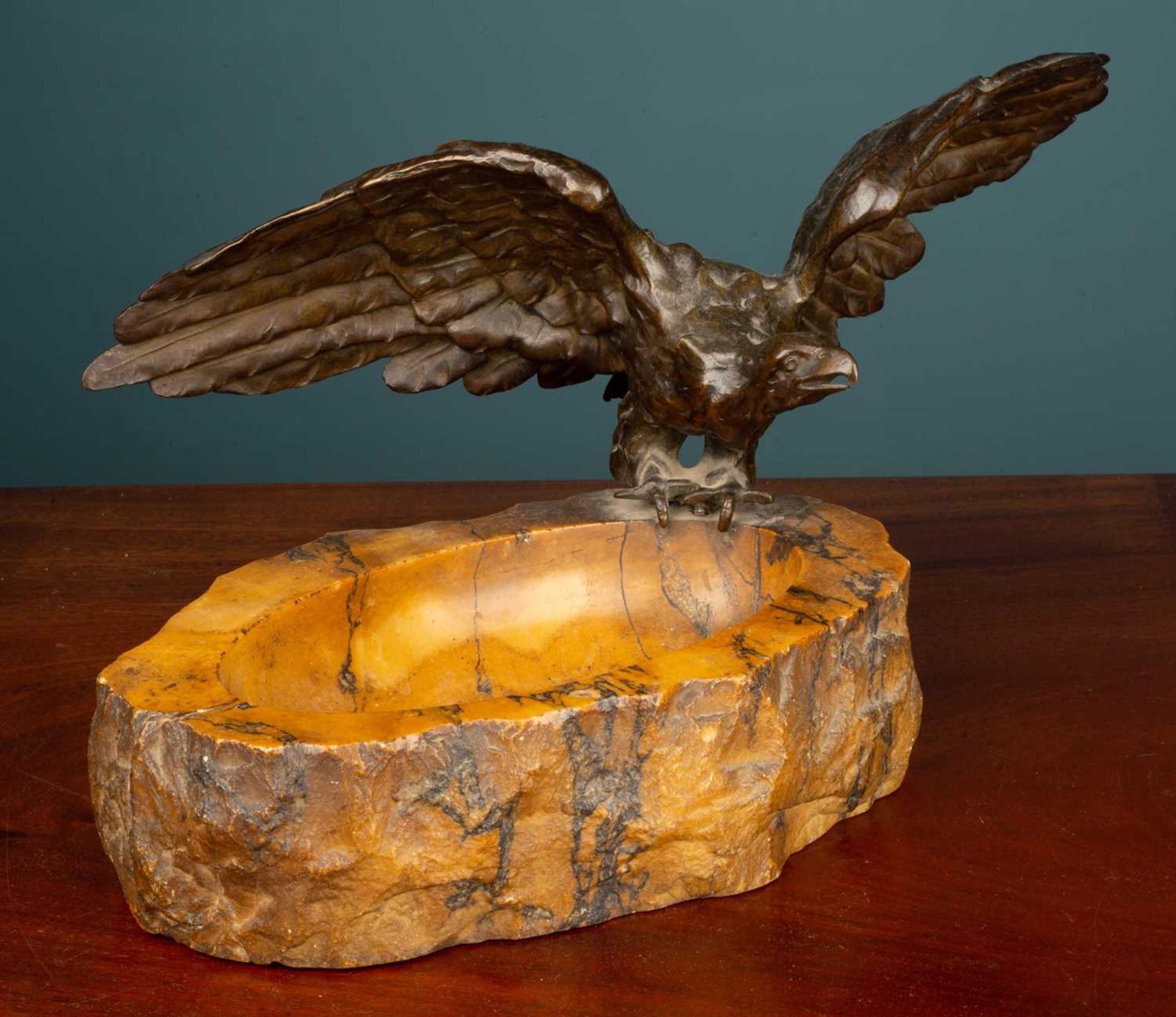 A carved hardstone dish mounted with a bronze sculpture of an eagle