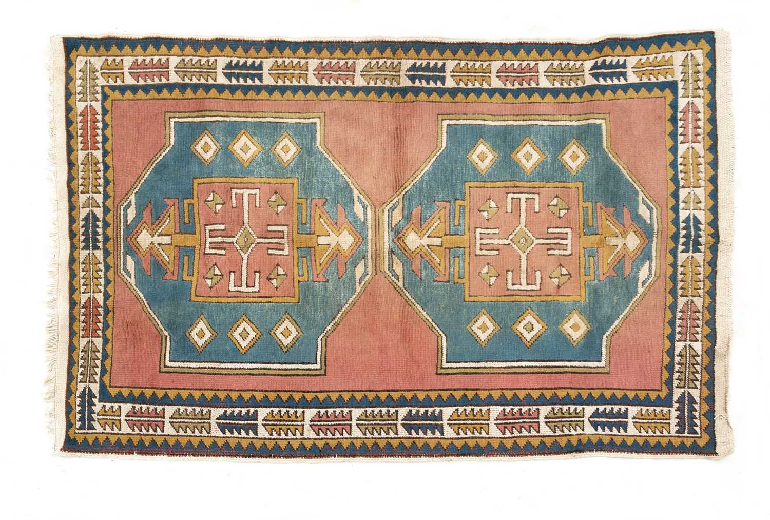 A mid to late 20th century Turkish cream, red and blue ground woolen rug